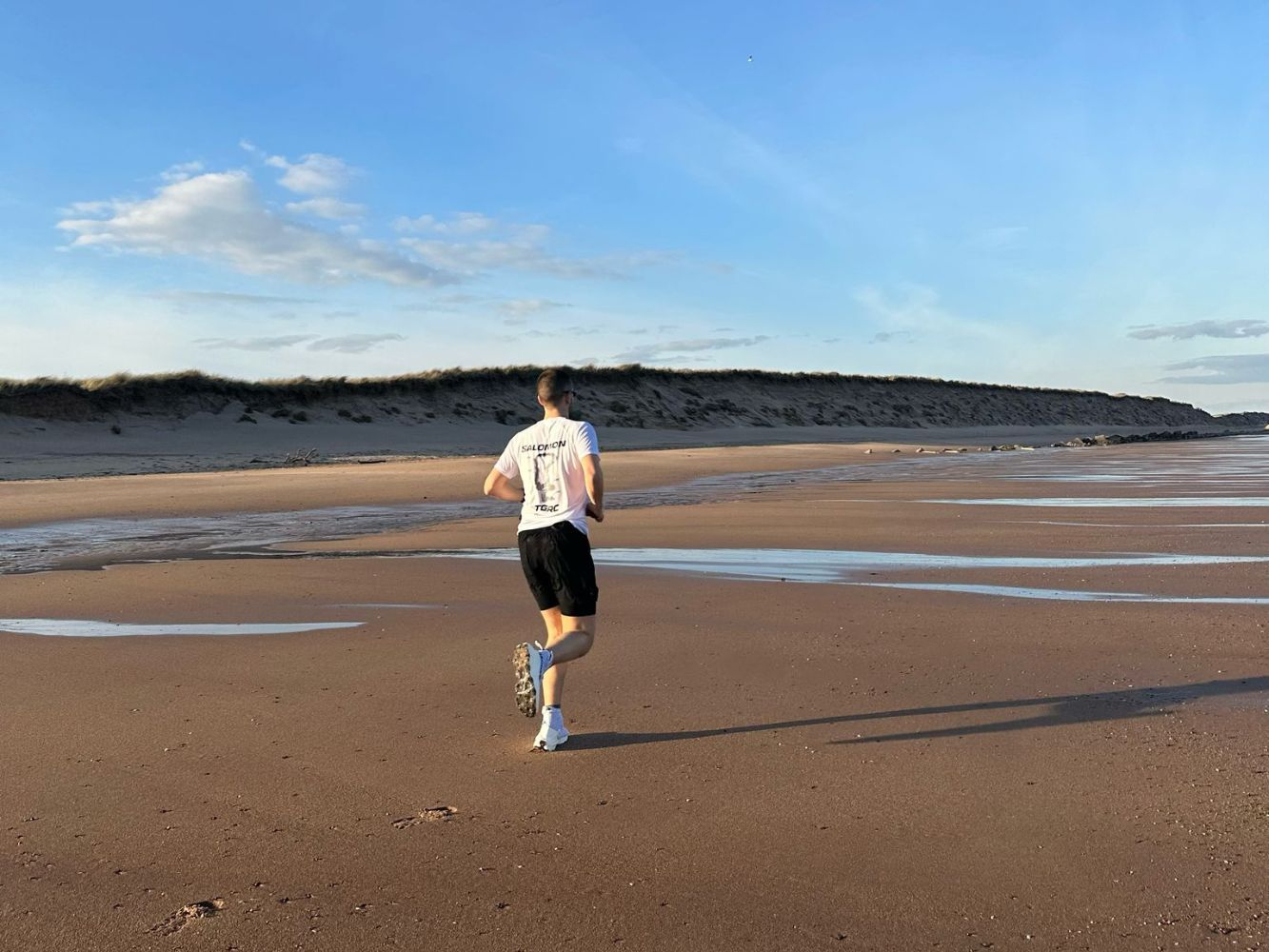 Jayden running along the beach in Aberdeen