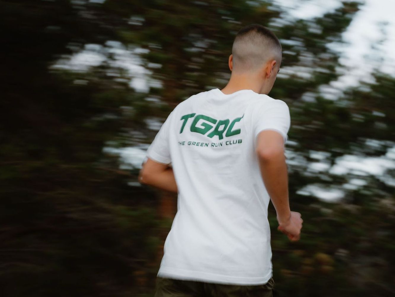 Jayden running wearing a The Green Run Club tshirt