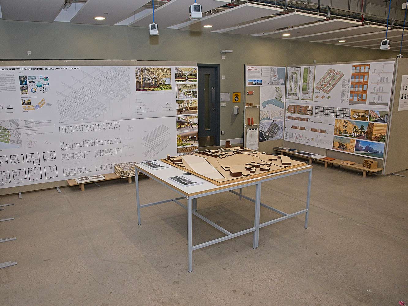 table with architectural model and display boards with technical drawings