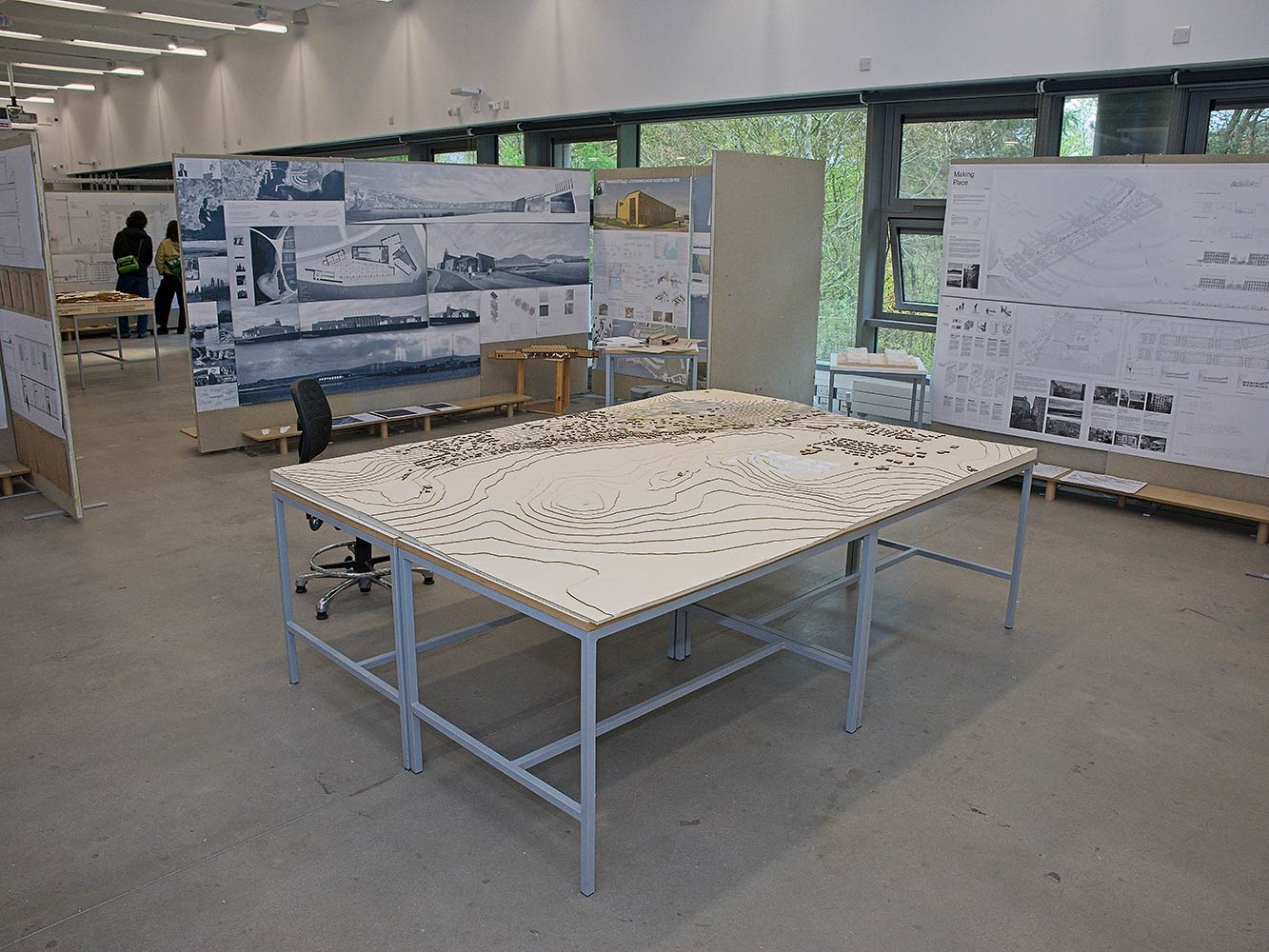 table with architectural model and display boards with technical drawings