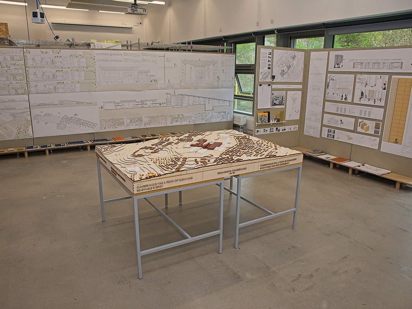 table with architectural model and display boards with technical drawings