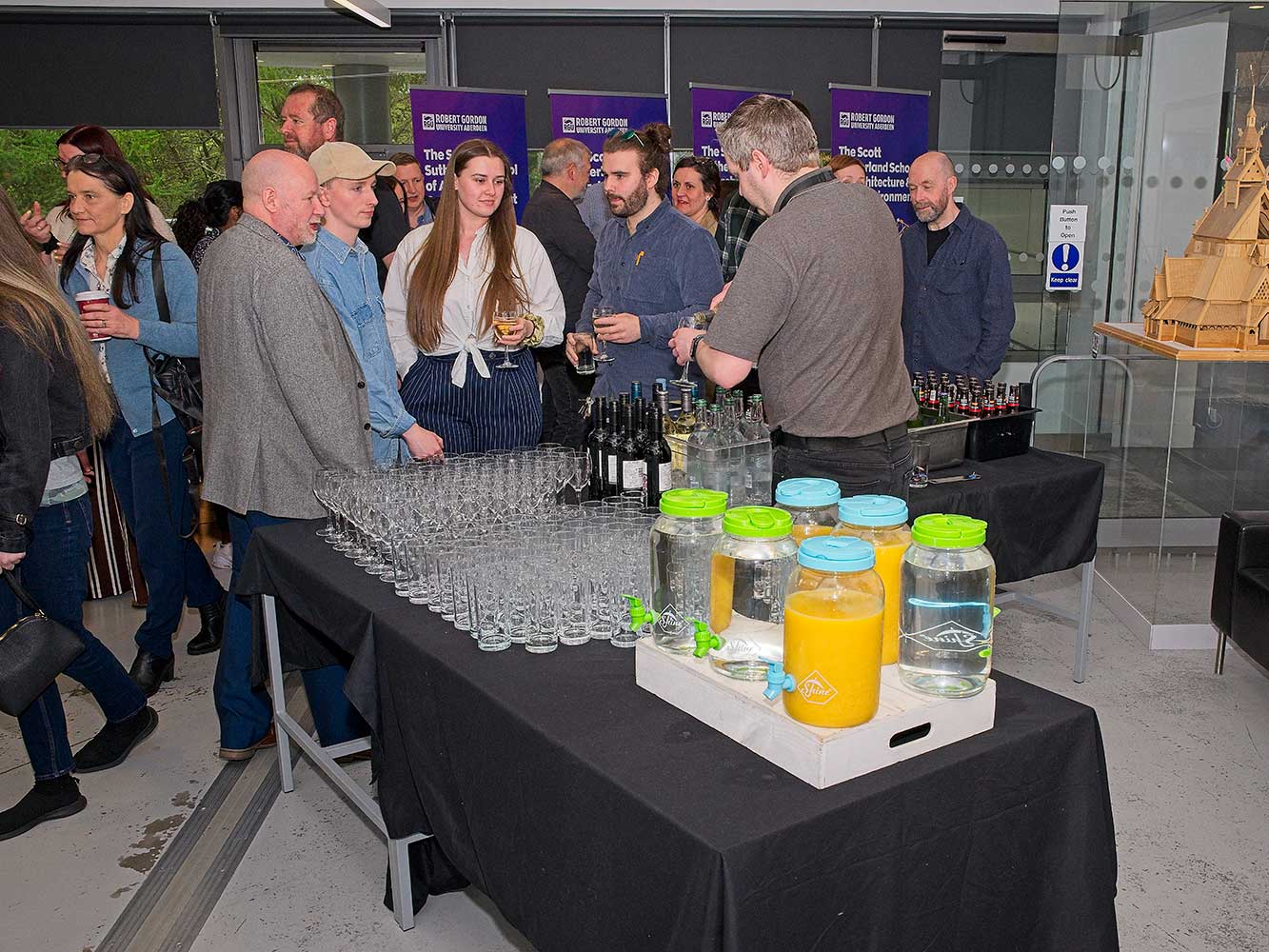 attendees of an event chatting and collecting drinks