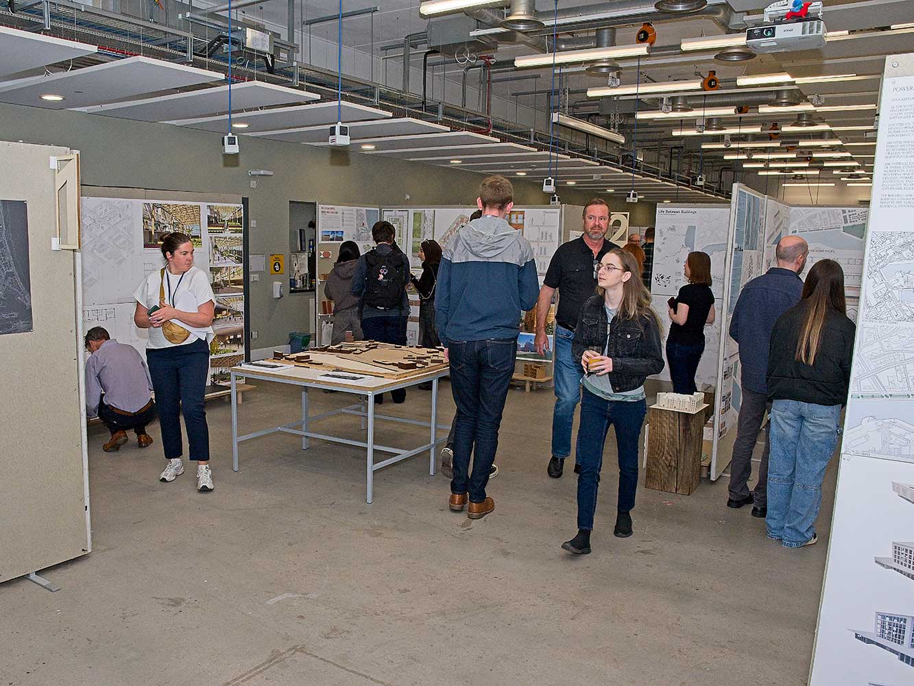 attendees looking at architectural models and drawings