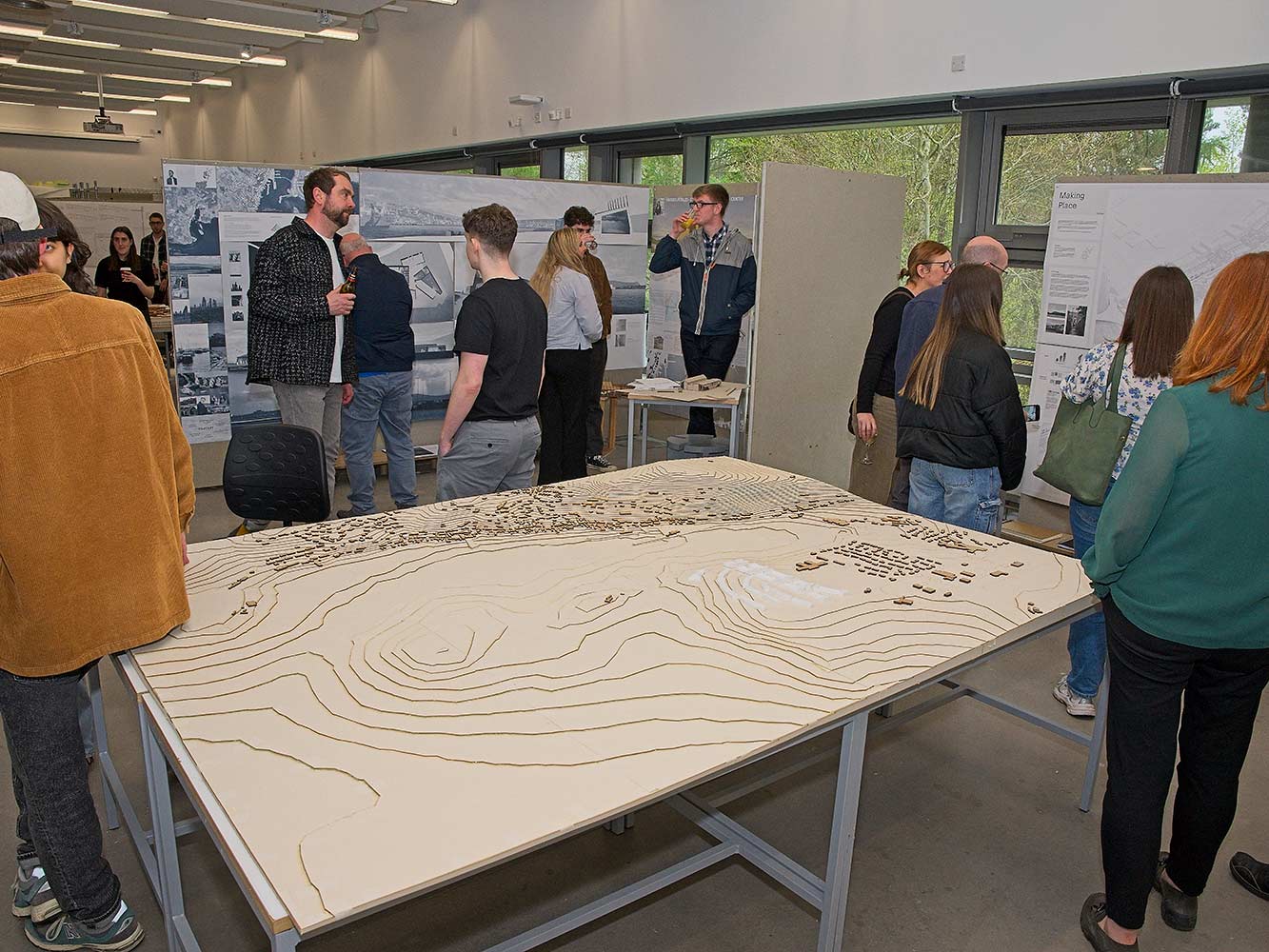attendees looking at architectural models and drawings