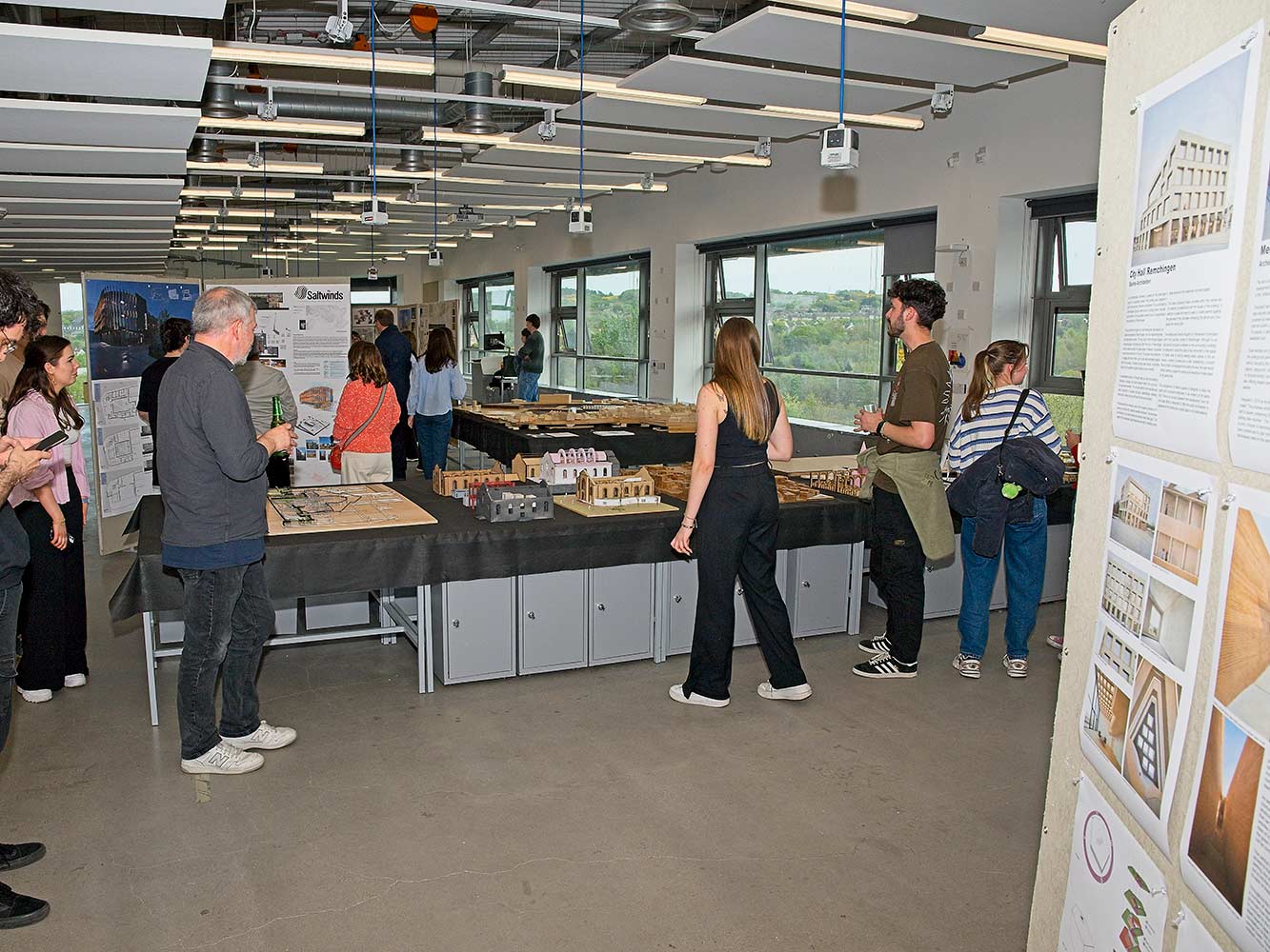 people looking at architectural models