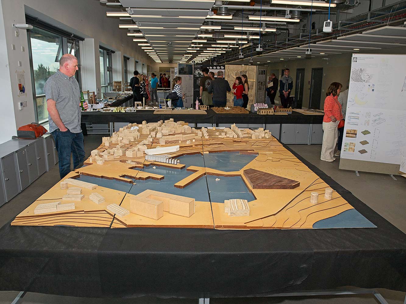 man looking at a large architectural model