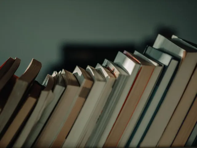 row of leaning books