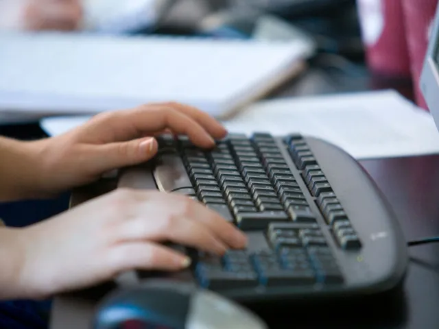 person typing on keyboard