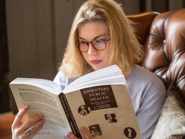 woman reading a public health book
