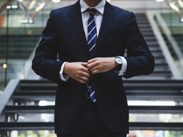 person adjusting their suit