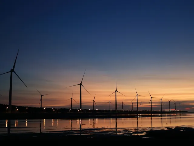 windfarm on the sea at sunset