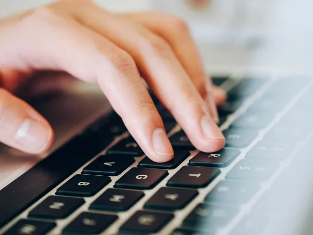 person typing on keyboard