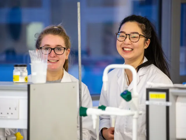 students smiling in a laboratory