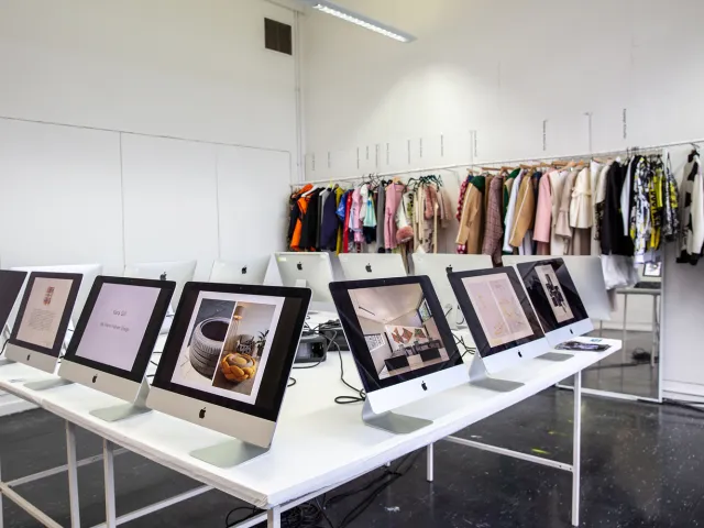 student garments hanging next to computer screens
