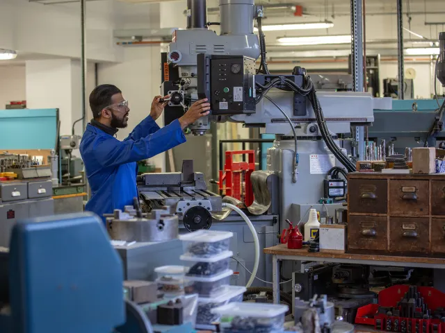 man working on device in engineering workshop