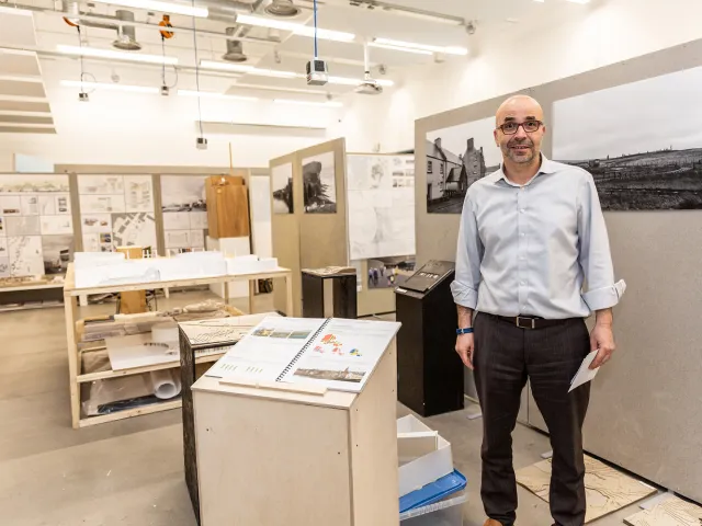 man standing in front of degree show display