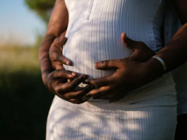 Hands Of A Couple Embracing The Baby Inside Her Growing Belly