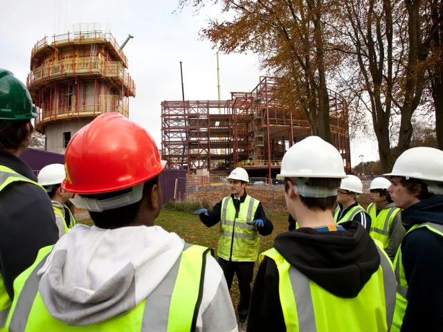 people on a building site wearing high vis and hard hats