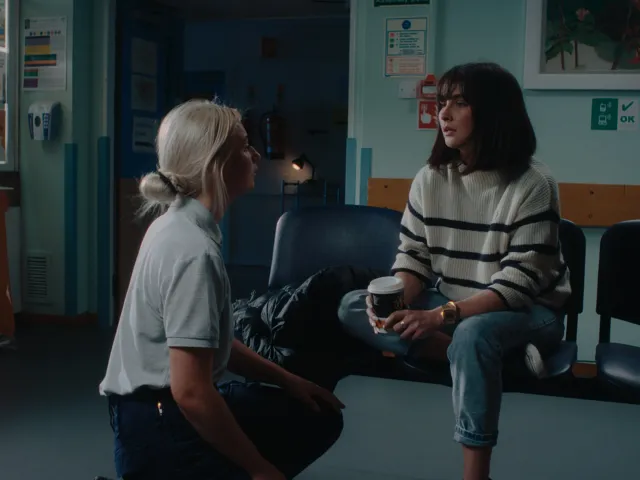 health professional speaking to a patient in a waiting room