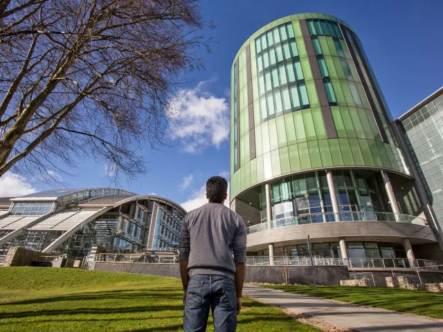 student looking up at RGU campus