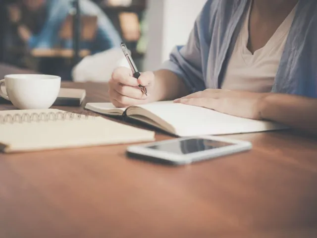 Person writing in a notebook