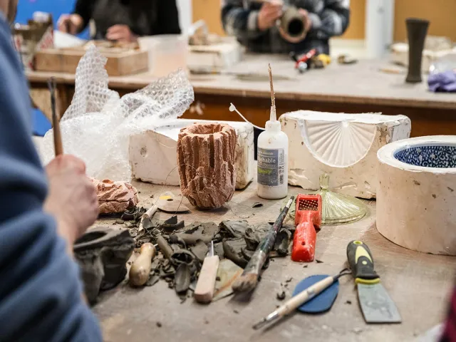 students learning how to use ceramic moulds
