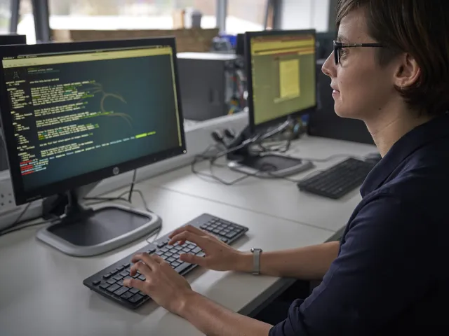 student writing code on computer