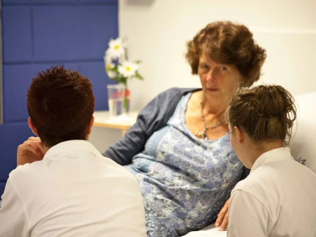two health professionals attending to a patient