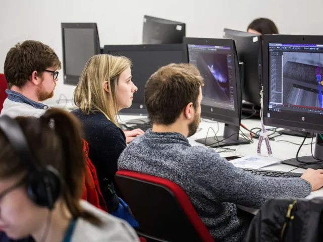 student sitting with a lecturer looking at a 3D model