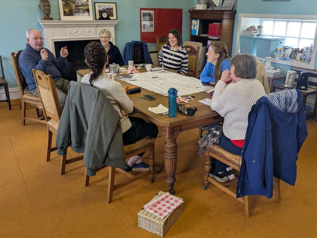 group of people sitting around a table