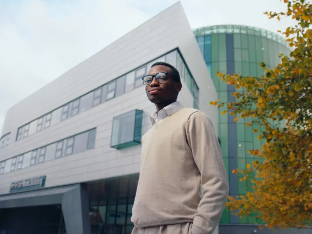 student stands outside the Sir Ian Wood Building