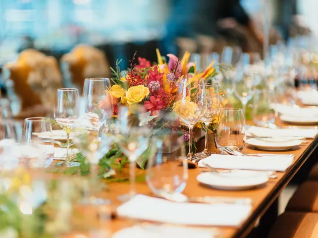 close up of arranged table with wine glasses and flowers
