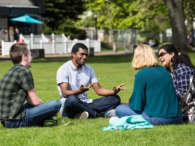 students chatting sat on the grass