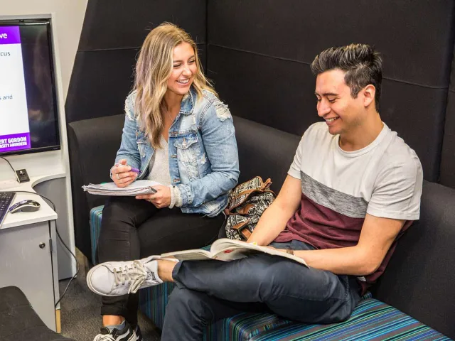 Two students socialising in study area