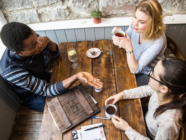 students chatting at a cafe table