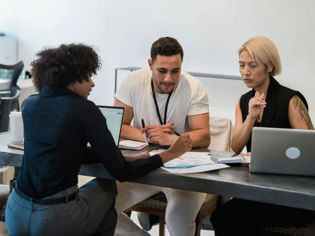 Three people during a meeting