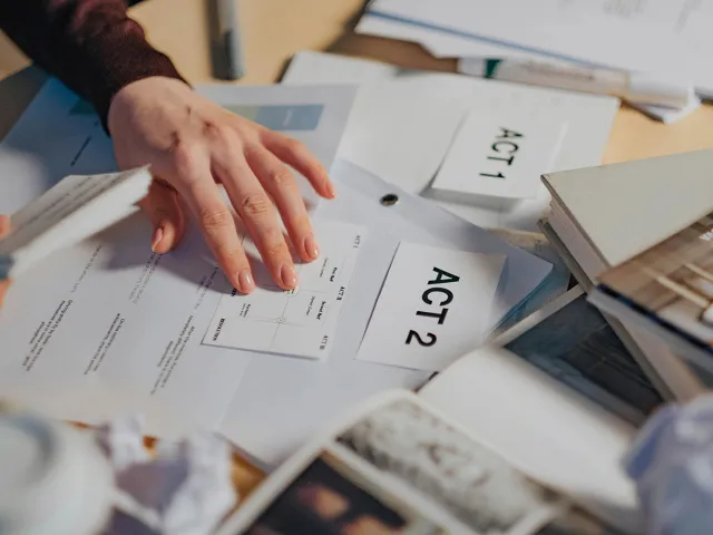 persons hand over some paperwork