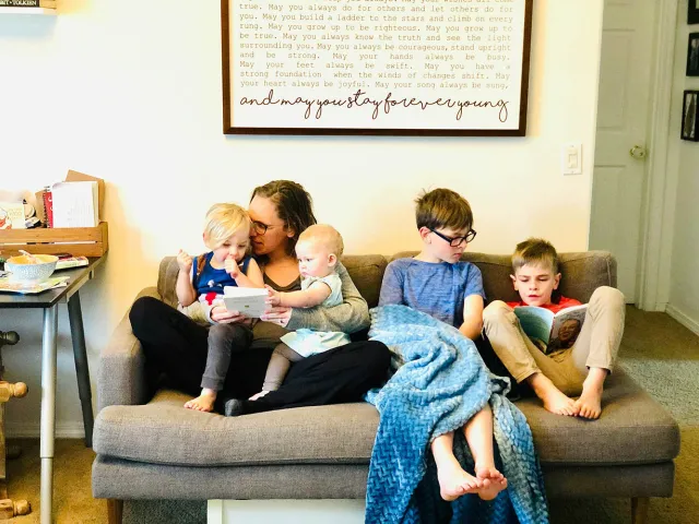 family sat on a sofa