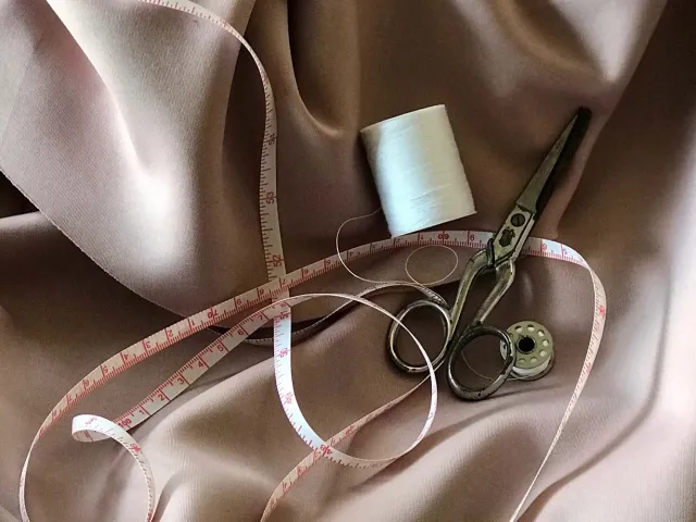 material, measuring tape, scissors and thread