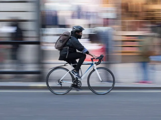 person cycling with blurred background