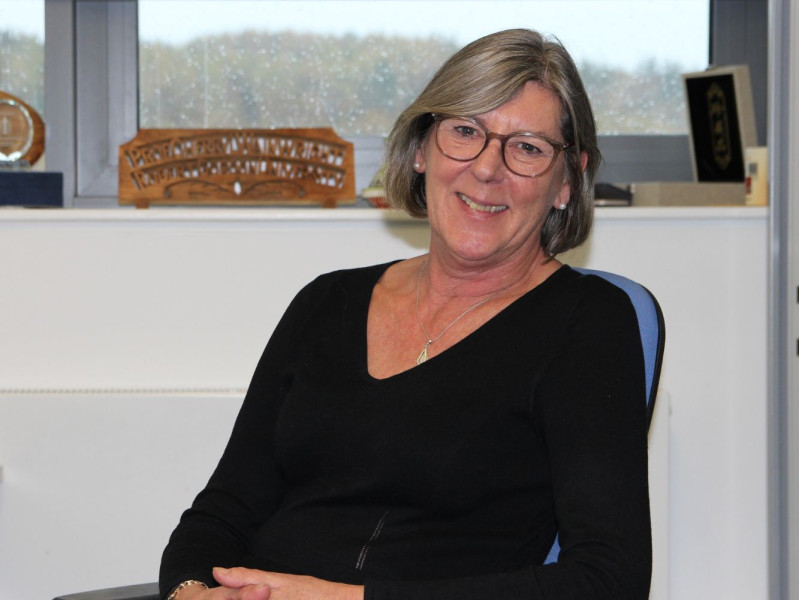 Professor Cherry Wainwright sitting on a chair