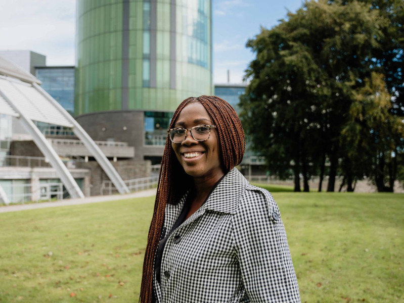 Dr Chioma Onoshakpor with the RGU Library in the background