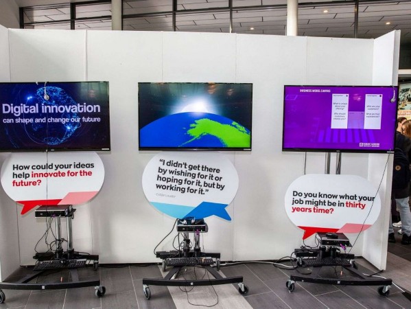 Athletes running along a red track on a sunny day