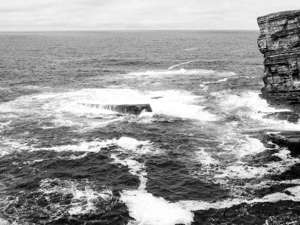 Black and white photograph of sea waves in Orkney