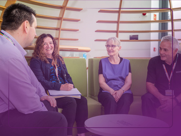 Staff sat in a park discussing