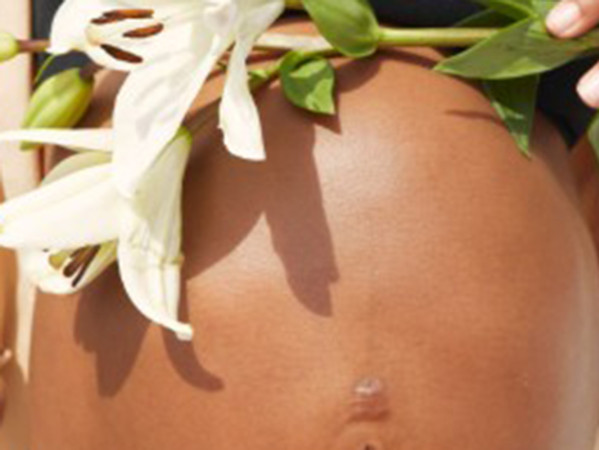 Woman's baby bump with lillies