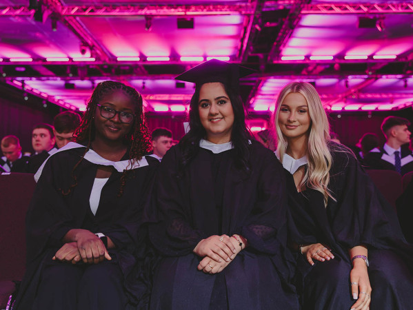 three graduates wait for their ceremony