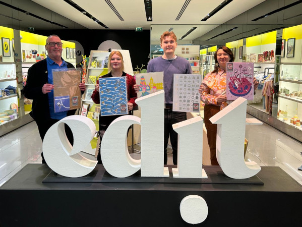 The students pose at Edit with their artwork