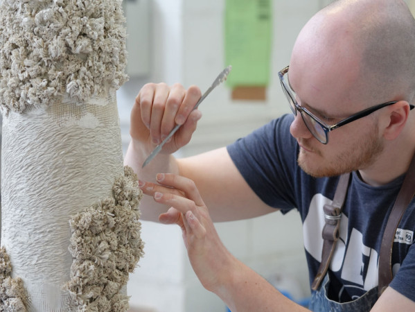 Max Ross decorating some pottery