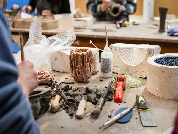 students learning how to use ceramic moulds